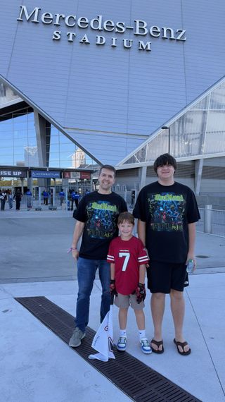 Me and my two sons outside Mercedes-Benz Stadium before the Falcons game, the older and I wearing OutKast ATLiens shirts and the younger in a Falcons jersey